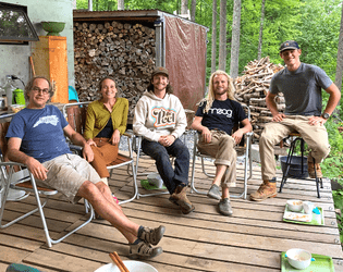 Cameron Van Dyke sits with his wife and students at their sustainable community