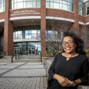Appalachian State University alumna Lynn Patterson ’89, who holds a B.S. in communication studies, has been employed at App State’s library for 30 years. She is pictured in front of the university’s Belk Library and Information Commons, in which she is a university program specialist. Photo by Marie Freeman