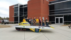 Members of the team with their solar vehicle