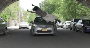 Woman jumping in front of a car